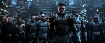 Movie still from “The Chronicles of Riddick” (2004), directed by David Twohy – A group of men standing next to each other in armor; Medium shot, Low angle