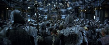 Movie still from “The Chronicles of Riddick” (2004), directed by David Twohy – A group of people standing in front of a building; Extreme Wide shot, High angle