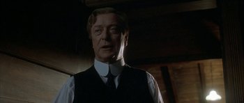 Movie still from “The Cider House Rules” (1999), directed by Lasse Hallström – A person wearing a suit and tie; Close Up shot, Low angle