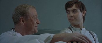 Movie still from “The Cider House Rules” (1999), directed by Lasse Hallström – A man and a woman talking to each other in front of a wall; Close Up shot, Over the shoulder angle