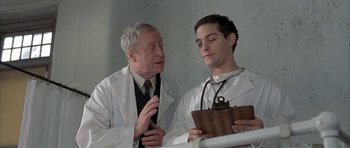 Movie still from “The Cider House Rules” (1999), directed by Lasse Hallström – A doctor and a patient talking to each other; Medium shot, Low angle