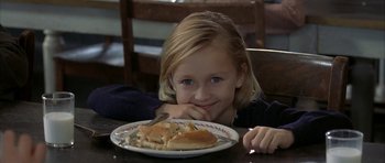 Movie still from “The Cider House Rules” (1999), directed by Lasse Hallström – A young girl sitting in front of a plate of food; Close Up shot, Over the shoulder angle