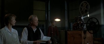 Movie still from “The Cider House Rules” (1999), directed by Lasse Hallström – A man and a woman sitting next to each other in front of a lamp; Medium shot, Low angle