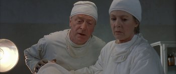 Movie still from “The Cider House Rules” (1999), directed by Lasse Hallström – A man and a woman wearing white medical clothing; Close Up shot, Over the shoulder angle