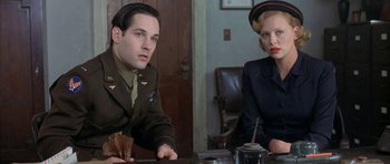 Movie still from “The Cider House Rules” (1999), directed by Lasse Hallström – A man and a woman sitting at a table in a room; Medium shot, Low angle