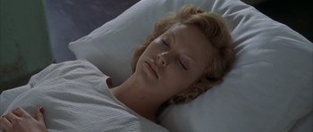 Movie still from “The Cider House Rules” (1999), directed by Lasse Hallström – A woman laying in bed with her eyes closed; Close Up shot, High angle