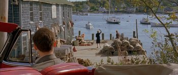 Movie still from “The Cider House Rules” (1999), directed by Lasse Hallström – A woman standing on a dock next to a body of water; Wide shot, High angle