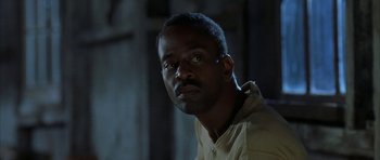 Movie still from “The Cider House Rules” (1999), directed by Lasse Hallström – A man with a beard is looking at the camera; Close Up shot, Low angle