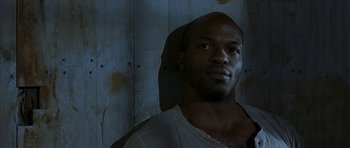 Movie still from “The Cider House Rules” (1999), directed by Lasse Hallström – A man with a beard is looking at the camera; Close Up shot, Low angle