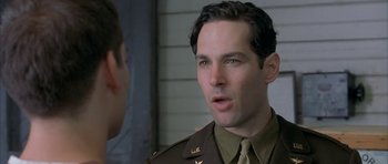 Movie still from “The Cider House Rules” (1999), directed by Lasse Hallström – A person wearing a uniform; Close Up shot, Over the shoulder angle