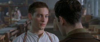 Movie still from “The Cider House Rules” (1999), directed by Lasse Hallström – A young man looking at another young man in front of a window; Close Up shot, Over the shoulder angle