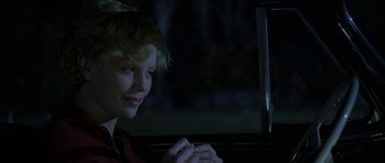 Movie still from “The Cider House Rules” (1999), directed by Lasse Hallström – A woman sitting in the back seat of a car at night; Close Up shot, Over the shoulder angle