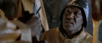Movie still from “The Cider House Rules” (1999), directed by Lasse Hallström – An older man wearing a metal helmet is looking into the camera; Close Up shot, High angle