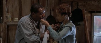 Movie still from “The Cider House Rules” (1999), directed by Lasse Hallström – A man and a woman eating food together; Medium shot, Low angle
