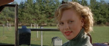 Movie still from “The Cider House Rules” (1999), directed by Lasse Hallström – A person wearing a sweater near a fence; Close Up shot, Over the shoulder angle