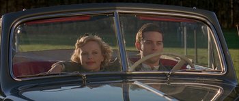 Movie still from “The Cider House Rules” (1999), directed by Lasse Hallström – A man and a woman sitting in the drivers seat of a car; Medium shot, Low angle