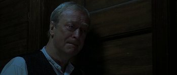 Movie still from “The Cider House Rules” (1999), directed by Lasse Hallström – An older man is looking at the camera; Close Up shot, Low angle