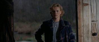 Movie still from “The Cider House Rules” (1999), directed by Lasse Hallström – A woman with blonde hair wearing a plaid coat; Medium shot, Over the shoulder angle