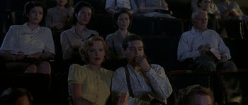 Movie still from “The Cider House Rules” (1999), directed by Lasse Hallström – A group of people sitting in a room; Medium shot, Low angle