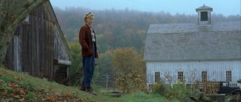 Movie still from “The Cider House Rules” (1999), directed by Lasse Hallström – A woman standing on top of a grass covered hillside; Wide shot, Low angle