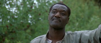 Movie still from “The Cider House Rules” (1999), directed by Lasse Hallström – A person looking up with trees in the background; Close Up shot, Low angle