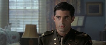 Movie still from “The Cider House Rules” (1999), directed by Lasse Hallström – A man in a military uniform looking at the camera; Close Up shot, Over the shoulder angle
