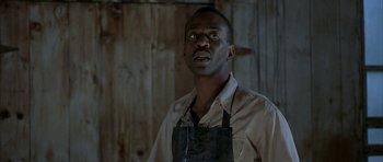 Movie still from “The Cider House Rules” (1999), directed by Lasse Hallström – A man wearing an apron looking up at the sky; Close Up shot, Low angle