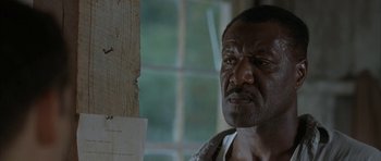 Movie still from “The Cider House Rules” (1999), directed by Lasse Hallström – An older black man looking at the camera; Close Up shot, Low angle