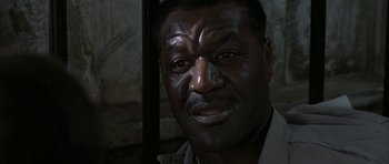 Movie still from “The Cider House Rules” (1999), directed by Lasse Hallström – A man's face in a dimly - lit room; Close Up shot, Low angle