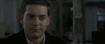 Movie still from “The Cider House Rules” (1999), directed by Lasse Hallström – A person wearing a black jacket; Close Up shot, Over the shoulder angle