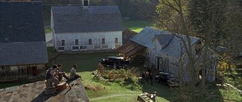 Movie still from “The Cider House Rules” (1999), directed by Lasse Hallström – A group of people standing around a car that has fallen off of it's roof; Extreme Wide shot, High angle