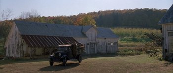 Movie still from “The Cider House Rules” (1999), directed by Lasse Hallström – An old truck parked in front of an old barn; Extreme Wide shot, High angle