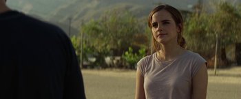 Movie still from “The Circle” (2017), directed by James Ponsoldt – A woman standing next to a man in a field; Close Up shot, Over the shoulder angle