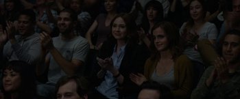 Movie still from “The Circle” (2017), directed by James Ponsoldt – A woman clapping while sitting in a crowd of people; Medium shot, Over the shoulder angle