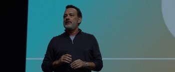 Movie still from “The Circle” (2017), directed by James Ponsoldt – A man standing in front of a projector screen; Close Up shot, Over the shoulder angle