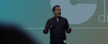 Movie still from “The Circle” (2017), directed by James Ponsoldt – A man standing in front of a green screen; Close Up shot, Over the shoulder angle