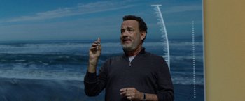 Movie still from “The Circle” (2017), directed by James Ponsoldt – A man standing in front of an image of the ocean; Medium shot, Low angle