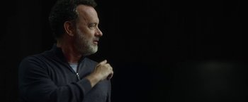 Movie still from “The Circle” (2017), directed by James Ponsoldt – A man standing in front of a black background; Close Up shot, Over the shoulder angle