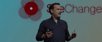 Movie still from “The Circle” (2017), directed by James Ponsoldt – A man standing in front of a projection screen; Close Up shot, Over the shoulder angle