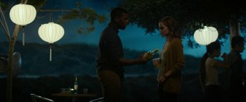 Movie still from “The Circle” (2017), directed by James Ponsoldt – A man and a woman standing next to each other holding drinks; Medium shot, Over the shoulder angle