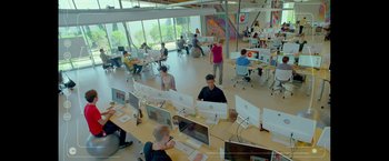 Movie still from “The Circle” (2017), directed by James Ponsoldt – A group of people sitting at computers in an office setting; Extreme Wide shot, High angle