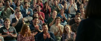 Movie still from “The Circle” (2017), directed by James Ponsoldt – A large group of people clapping in a stadium; Medium shot, Over the shoulder angle