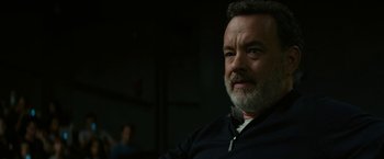 Movie still from “The Circle” (2017), directed by James Ponsoldt – A man with a gray beard is looking at the camera; Close Up shot, Over the shoulder angle