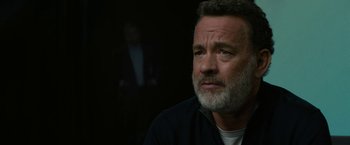 Movie still from “The Circle” (2017), directed by James Ponsoldt – A man with a gray beard is looking into the distance; Close Up shot, Over the shoulder angle