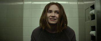 Movie still from “The Circle” (2017), directed by James Ponsoldt – A woman with long red hair is standing in a bathroom; Close Up shot, Over the shoulder angle