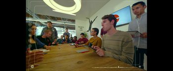 Movie still from “The Circle” (2017), directed by James Ponsoldt – A group of young men sitting around a table; Wide shot, Over the shoulder angle