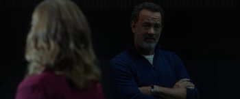 Movie still from “The Circle” (2017), directed by James Ponsoldt – A person sitting in a room near a wall; Medium shot, Over the shoulder angle