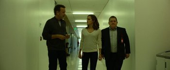 Movie still from “The Circle” (2017), directed by James Ponsoldt – Two men and a woman walking down a hallway; Wide shot, Low angle