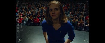 Movie still from “The Circle” (2017), directed by James Ponsoldt – A woman in a blue dress in front of an audience; Close Up shot, Over the shoulder angle