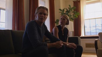 Movie still from “Full Circle” (2023), directed by Steven Soderbergh – A man and a woman are playing a video game together; Medium shot, Low angle